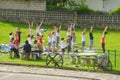 COLUNGA, SPAIN - Jun 01, 2016: yoga teacher and children learning yoga on the grass