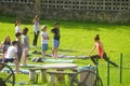 COLUNGA, SPAIN - Jun 01, 2016: yoga teacher and children learning yoga on the grass