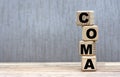 COMA word on cubes on a beautiful gray background Royalty Free Stock Photo