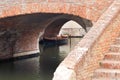 Comacchio, Italy. Boat under the old bridge Ponte degli Sbirri Royalty Free Stock Photo