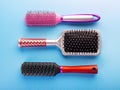 Comb brushes set. Different hairbrushes for female hair on blue background Royalty Free Stock Photo