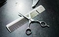 Comb and scissors on a dirty table