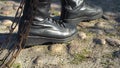 Combat boots tugging chain prison concept