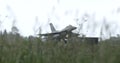 Combat Fighter Jet Rain Landing Amid Tall Grass