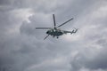 Combat helicopters fly against the background of the cloudy sky. Cloudy sky.