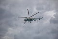 Combat helicopters fly against the background of the cloudy sky. Cloudy sky.