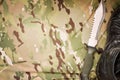 Combat knife and shoes on military camouflage fabric background Royalty Free Stock Photo