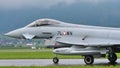 Combat military jet aircraft taxi on the runway in a raining day. Copy Space.