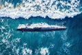 Combat military nuclear diesel electric submarine on background of blue ocean water. Top view aerial drone Royalty Free Stock Photo