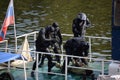 Combat swimmers work out the capture of a terrorist at the stern of a river vessel.