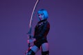 Combative cyberpunk woman with sword indoors studio