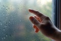 Combatting moisture, Hand removes window condensation in a humid home