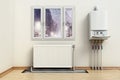 Combi boiler on the house wall, next to the heating radiator. Visible installation of heating tubes. 3D illustration Royalty Free Stock Photo