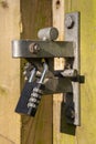 Combination padlock secures a wooden gate