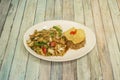 Combination plate of chicken with noodles and vegetables, chaufa rice