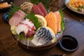 Combination sashimi set consisting of pickled saba, salmon, squid, tuna and hamachi on a dark bowl Royalty Free Stock Photo