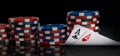 The combination of two aces is reflected on the surface of the black background, surrounded by the chips of a large bet for poker Royalty Free Stock Photo