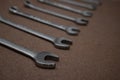 Combination wrenches lined up on wooden board with selective focus Royalty Free Stock Photo