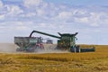 Combine loading harvest into grain cart Royalty Free Stock Photo