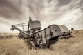 Antique combine left if a field to rot in Norther Idaho farm country