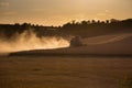 Combine harvested grain at sunset