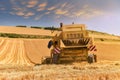 combine harvester in action in grain fields in summer Royalty Free Stock Photo