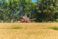 Combine harvester in action on rice field. Harvesting is the process of gathering a ripe crop from the fields Royalty Free Stock Photo