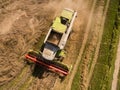 Combine harvester - Aerial view of modern combine harvester at the harvesting the wheat on the golden wheat field in the summer Royalty Free Stock Photo