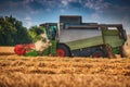 Combine harvester agriculture machine harvesting golden ripe wheat field