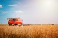 Combine harvester agriculture machine harvesting ripe wheat in farm field Royalty Free Stock Photo