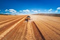 Combine harvester agriculture machine harvesting golden ripe wheat field Royalty Free Stock Photo