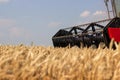 Combine harvester close up. Combine harvester harvesting wheat. Grain harvesting combine. Combine harvesting wheat. Wheat field bl Royalty Free Stock Photo