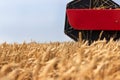 Combine harvester close up. Combine harvester harvesting wheat. Grain harvesting combine. Combine harvesting wheat. Wheat field bl Royalty Free Stock Photo