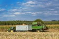 Combine harvester corn and discharge it into the trailer Royalty Free Stock Photo