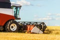 Combine harvester with cutter platform at work Royalty Free Stock Photo
