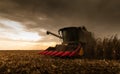 Combine harvester in evening action Royalty Free Stock Photo