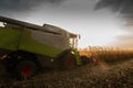 Combine harvester in evening action Royalty Free Stock Photo