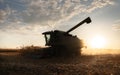 Combine harvester in evening action Royalty Free Stock Photo