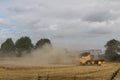 A combine harvester harvesting a crop of wheat in later summer In Yorkshire UK