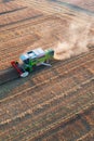 Combine harvester harvesting crops during sunset in Scotland