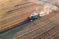 Combine harvester harvesting crops during sunset in Scotland