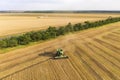 Combine harvester harvesting wheat, aerial view . Wheat field at sunset. Harvester working on wheat field Royalty Free Stock Photo