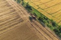 Combine harvester harvesting wheat, aerial view . Wheat field at sunset. Harvester working on wheat field