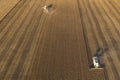 Combine harvester harvesting wheat, aerial view . Wheat field at sunset. Harvester working on wheat field