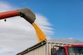 Combine harvester loading corn in grain truck Royalty Free Stock Photo