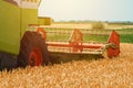 Combine harvester machine harvesting ripe wheat crops Royalty Free Stock Photo