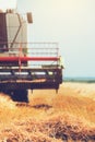 Combine harvester machine harvesting ripe wheat crops Royalty Free Stock Photo