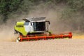 Combine, harvester mowing wheat field. Agriculture vehicle working Royalty Free Stock Photo