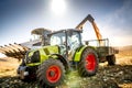 Combine harvester and tractor with trailer unloading harvest. Farmer working details. Agriculture industry machinery. Royalty Free Stock Photo