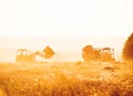 Combine harvester unloading grain into the trucks trailer